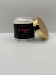 Skincare jar with black label and gold lid on a white background