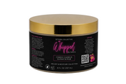 A jar of Setoria Collective Whipped Island Groove Sugar Scrub, featuring a black label with pink and white text and a metallic gold lid, set against a white background.