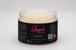 A jar of Setoria Collective Whipped Island Groove Sugar Scrub without a lid, featuring a black label with pink and white text set against a neutral gray background.